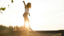 Woman balancing on a bar.