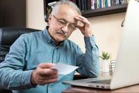 Senior man with pc. West Financial Services, Inc.