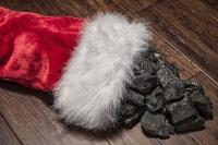 Red stocking with coal in it. West Financial Services.