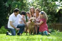 Family with their dog in their yard. West Financial Services.