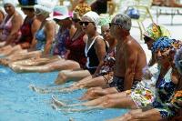 Mature people enjoying a pool. West Financial Services.