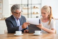 Man and woman looking at a pc. West Financial Services, Inc.