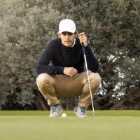 Golfer looks at his putt