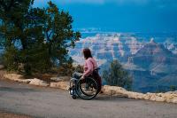 Woman in wheelchair looking at the mountains. West Financial Services, Inc.