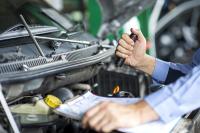 Man working on an engine. West Financial Services.